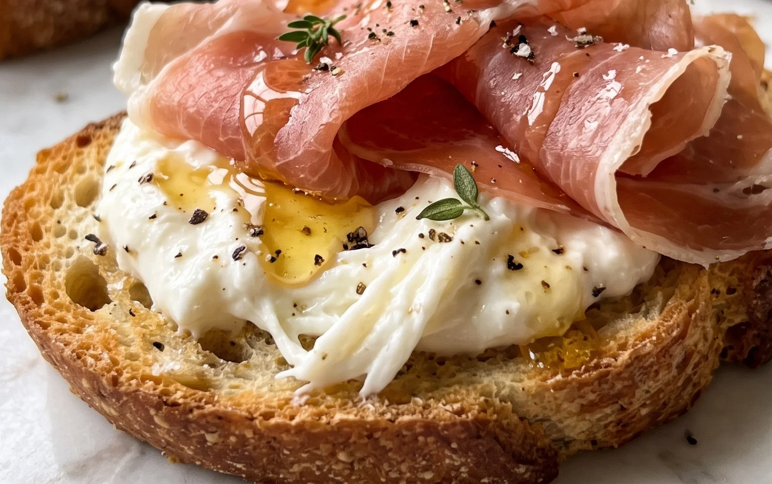 Beef Prosciutto Crostini with Burrata and Lemon Honey Drizzle