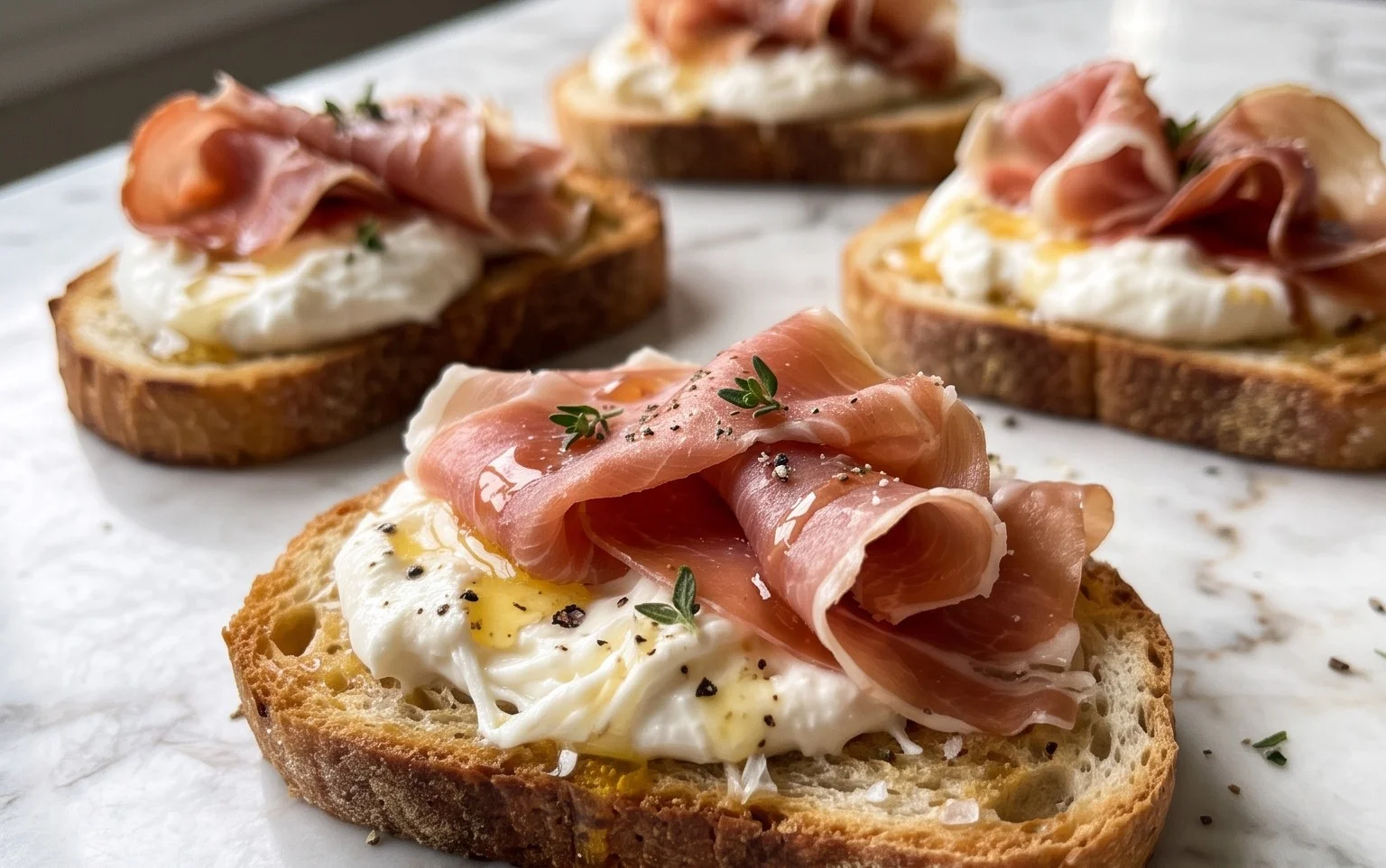Beef Prosciutto Crostini with Burrata and Lemon Honey Drizzle